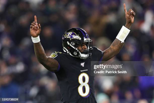 Quarterback Lamar Jackson of the Baltimore Ravens celebrates after throwing a touchdown pass to wide receiver Marquise Brown a against the New York...