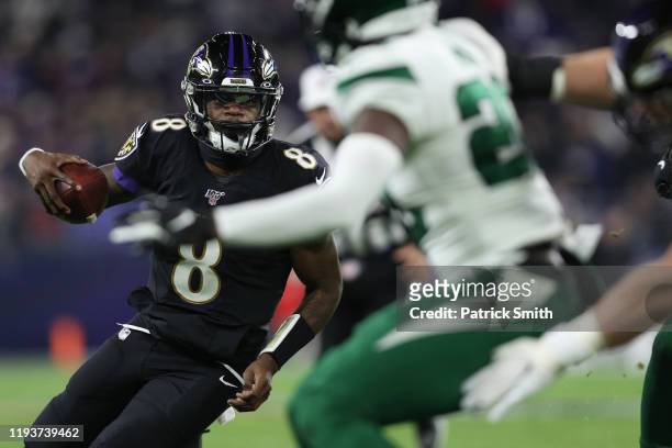 Quarterback Lamar Jackson of the Baltimore Ravens breaks NFL single season record for rushing yards by a quarterback, formerly held by Michael Vick,...