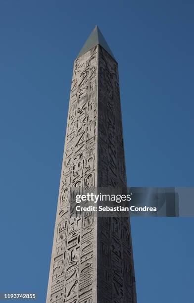 detail shot of the hieroglyphs on the obelisk in paris, france. - obelisk stock pictures, royalty-free photos & images