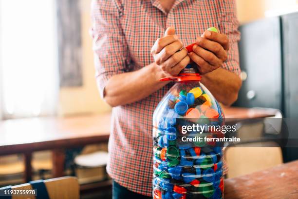 collecting bottle caps for charity - bottle cap stock pictures, royalty-free photos & images