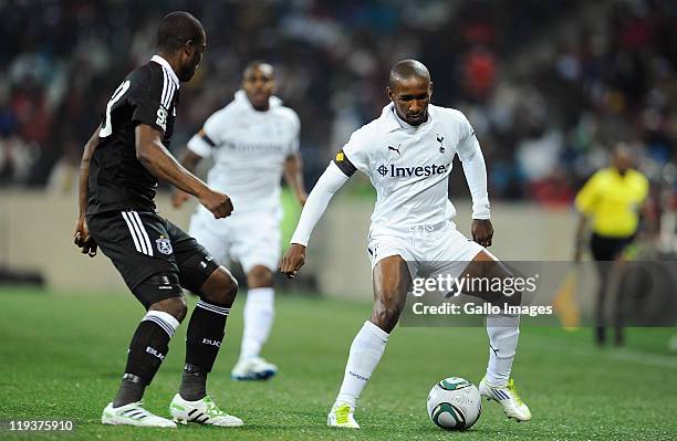 Jermain Defoe of Tottenham Hotspur and Rooi Mahamutsa of Orlando Pirates in action during the 2011 Vodacom Challenge match between Orlando Pirates...