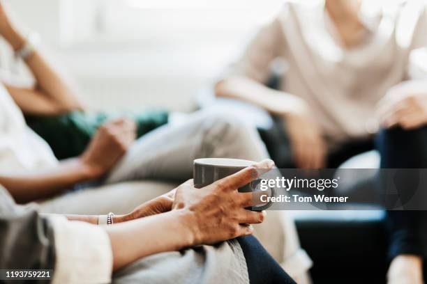 close up of woman holding cup of coffee at office - büro detail stock pictures, royalty-free photos & images