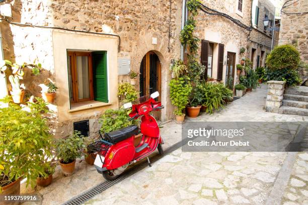mediterranean street with plants and red motorbike in the mallorca island. - old motorcycles bildbanksfoton och bilder