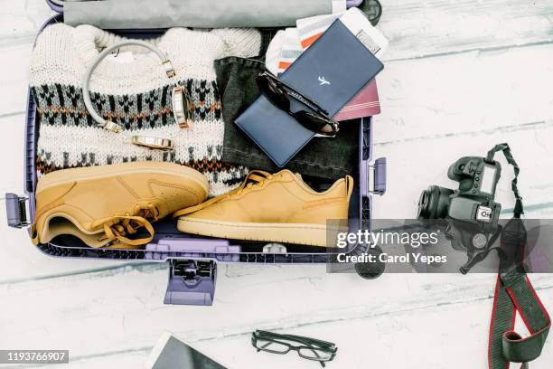 open suitcase with winter  travel items - open suitcase stock pictures, royalty-free photos & images