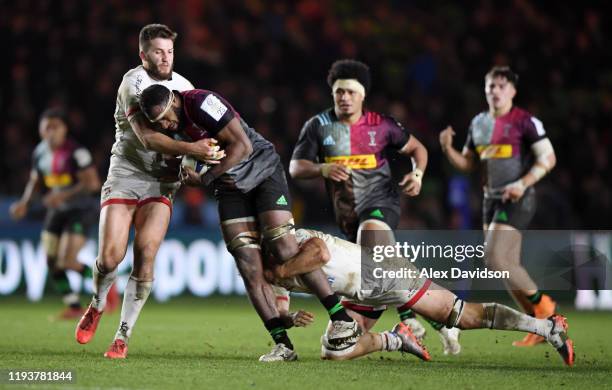 Semi Kunatani of Harlequins is tackled by Stuart McCloskey of Ulster and Jordi Murphy of Ulster during the Heineken Champions Cup Round 4 match...