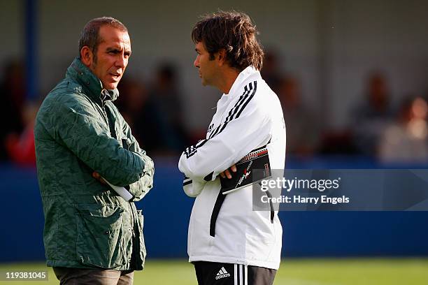 Swindon Town manager Paolo Di Canio talks with his assistant manager Fabrizio Piccareta looks on prior to the Pre Season Friendly match between...