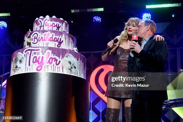 Taylor Swift and Elvis Duran pose onstage during iHeartRadio's Z100 Jingle Ball 2019 at Madison Square Garden on December 13, 2019 in New York City.