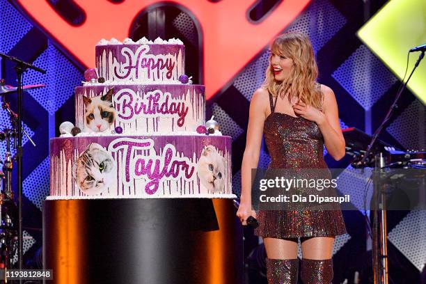 Taylor Swift poses with a giant birthday cake onstage during iHeartRadio's Z100 Jingle Ball 2019 Presented By Capital One on December 13, 2019 in New...