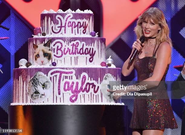 Taylor Swift poses with a giant birthday cake onstage during iHeartRadio's Z100 Jingle Ball 2019 Presented By Capital One on December 13, 2019 in New...