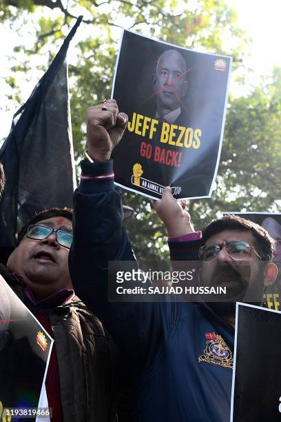 Traders hold placards during a demonstration demanding the closure of online shopping platforms Amazon and Flipkart, in New Delhi on January 15,...