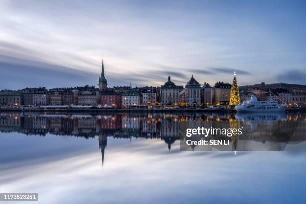 winter landscapes of stockholm old city during christmas, sunset view of stockholm harbor and big christmas tree - stockholm winter stock pictures, royalty-free photos & images