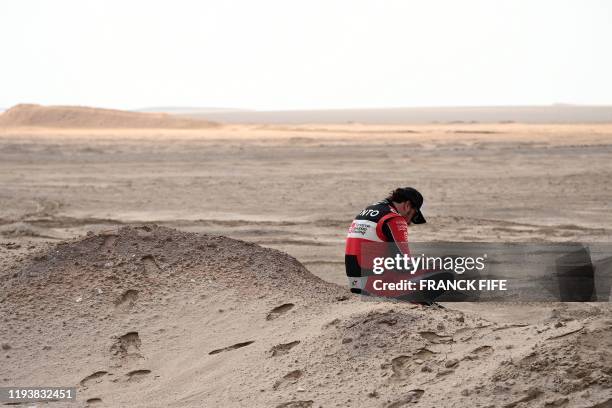 Toyota's Spanish driver Fernando Alonso reacts after the neutralisation of the race due to strong winds during the Stage 10 of the Dakar 2020 between...