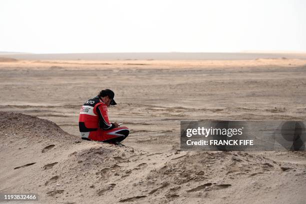 Toyota's Spanish driver Fernando Alonso reacts after the neutralisation of the race due to strong winds during the Stage 10 of the Dakar 2020 between...