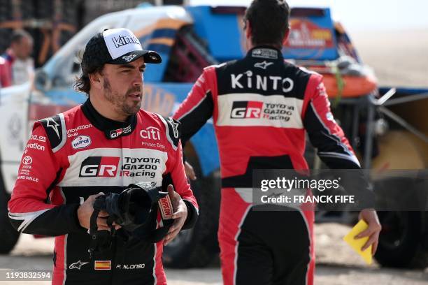 Toyota's Spanish driver Fernando Alonso reacts after the neutralisation of the race due to strong winds during the Stage 10 of the Dakar 2020 between...