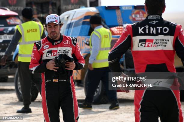 Toyota's Spanish driver Fernando Alonso reacts after the neutralisation of the race due to strong winds during the Stage 10 of the Dakar 2020 between...