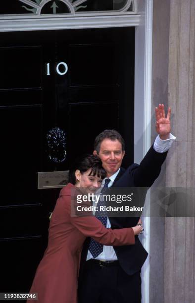 The newly-elected British Labour Prime Minister Tony Blair stands on the steps of Number 10 Downing Street with his wife Cherie, the morning after...