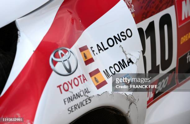 Picture taken on January 15, 2020 shows a detail of the damaged car of Toyota's Spanish driver Fernando Alonso and Spanish co-driver Marc Coma after...
