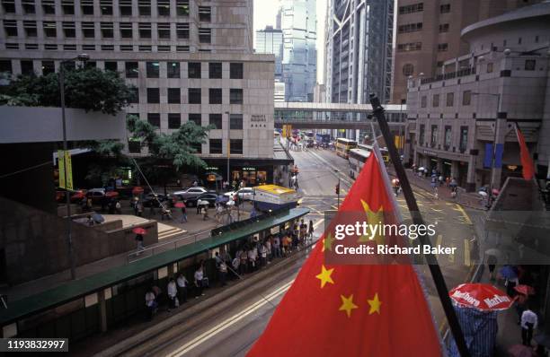 The Chinese flag hangs over Central, on the eve of the handover of sovereignty from Britain to China, on 30th June 1997, in Hong Kong, China....