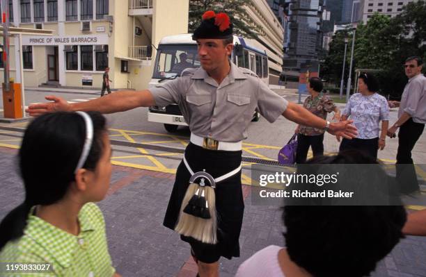 British soldier with the Scottish British Black Watch Regiment keeps the public safely away from a vehicle leaving the Prince of Wales Barracks, on...