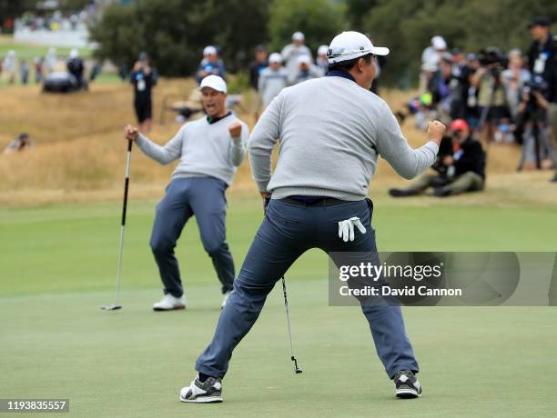 Byeong Hun An of the International Team celebrates holing a birdie putt on the 17th hole in his match with Adam Scott against Tony Finau and Matt...