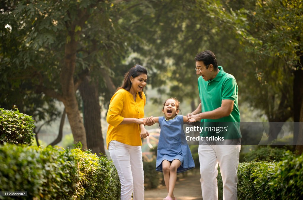 Happy family playing at park
