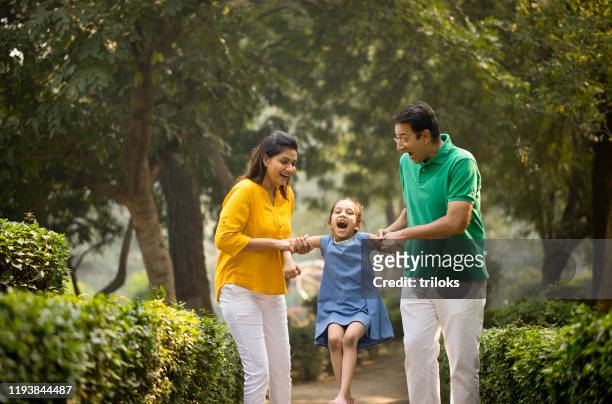 happy family playing at park - mum dad daughter stock pictures, royalty-free photos & images