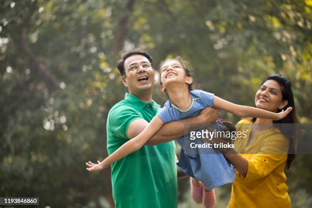 family having fun at park - parent stock pictures, royalty-free photos & images