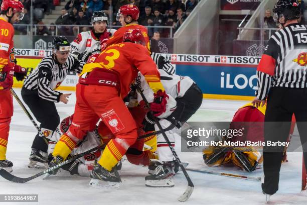 Joel Lundqvist and Max Friberg of Frolunda HF clash with Samuel Kreis and Mike Kunzle of EHC Biel during the second quarter-finals game between EHC...