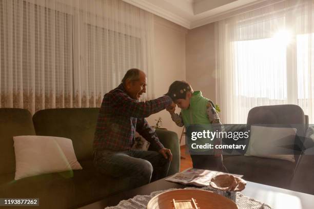 hand kissing ceremony in bayram - ramadhan stock pictures, royalty-free photos & images