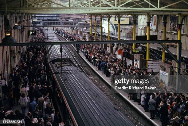 Seen from an aerial perspective during a rail strike in the 90s, on both sides of the railway track, thousands of commuters desperate to get home...