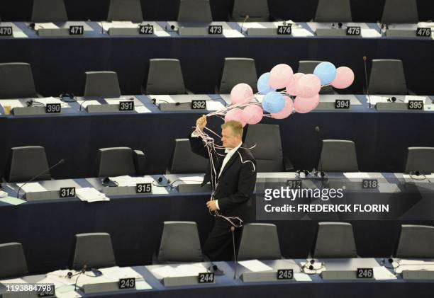 An usher collects balloons at the end of a vote on October 20, 2010 at the European Parliament in the northeastern Frnch city of Strasbourg in favor...