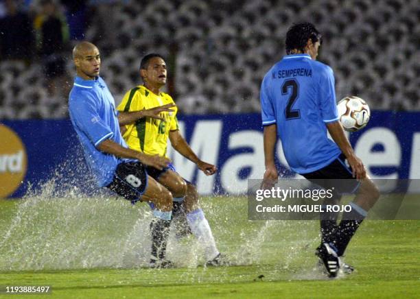 Soccer players Nelson Semperena , Carlos Diogo , and Wendel Goncalvez are seen fighting for the ball in Montevideo, Uruguay 09 January 2003. Nelson...