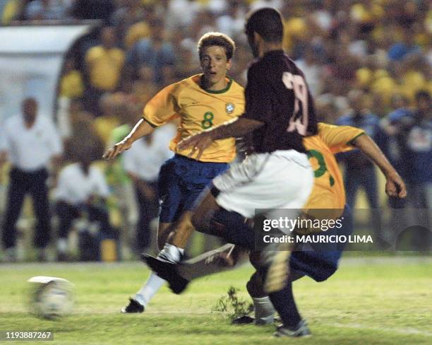 Luizao kicks the ball in front of his teammate Juninho Paulista as an unidentified player tries to stop the ball in Sao Luis, Brazil 14 November...