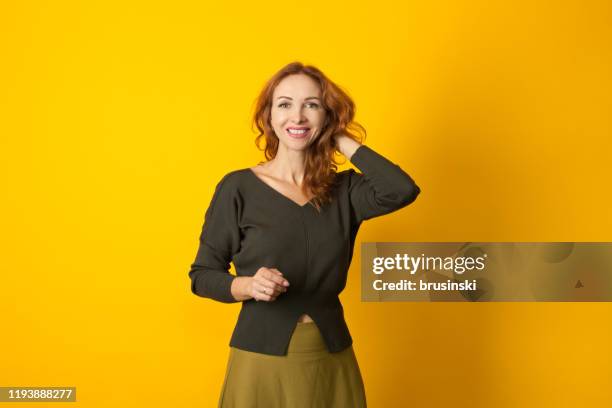 studio portrait of a 45 year old red-haired woman - year long stock pictures, royalty-free photos & images