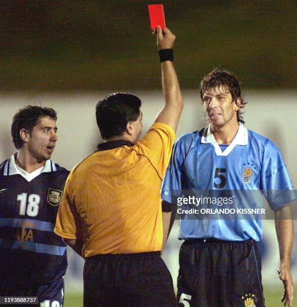 Mariano Messera of the Argentinian soccer team observed the referee, Byron Moreno expel Gabriel Garcia of Uruguay from the game 04 February, 2000 in...