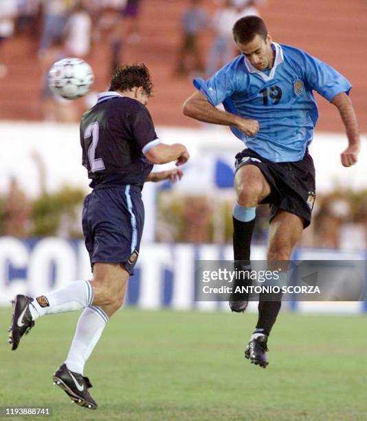 Ignacio Risso of Uruguay jumps to get the ball against Leandro Cufre of Argentina 04 February, 2000 in Londrina, Brazil. Argentina won the game over...