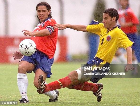 Colombia's Edwin Rivas fights for the ball with Chile's Hector Tapia ...