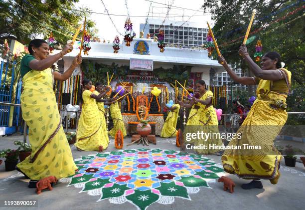 Women dance around a kolam drawing during Pongal festivities, at Tamil Nadu House, Chankyapuri on January 15, 2020 in New Delhi, India.