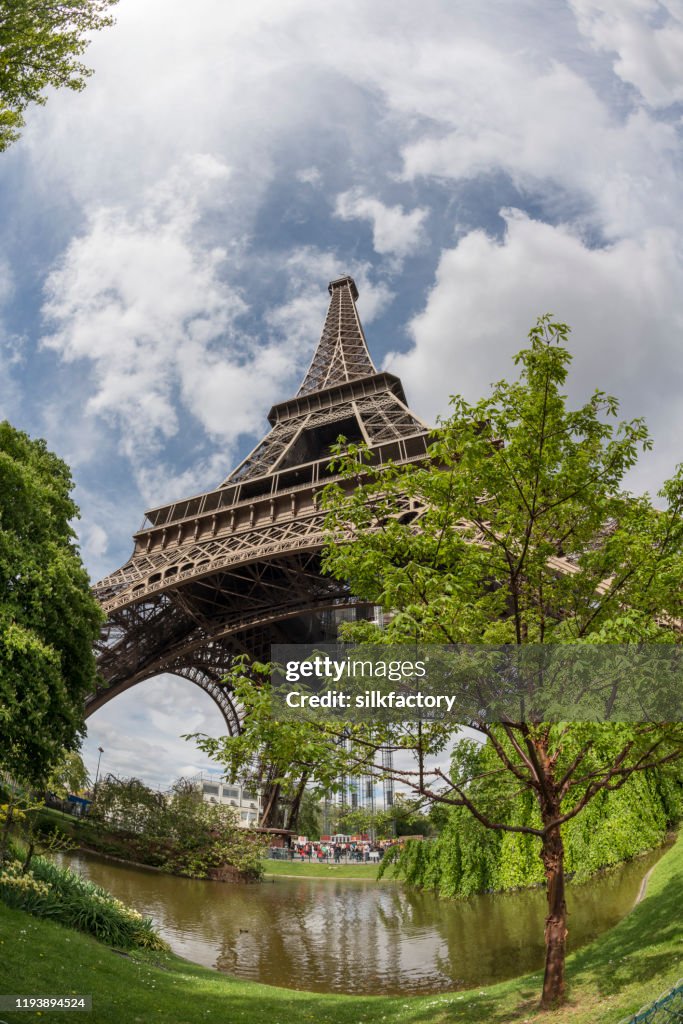 The iconic Parisian landmark Eiffel Tower and Champ de Mars on the Left Bank of Seine River in spring