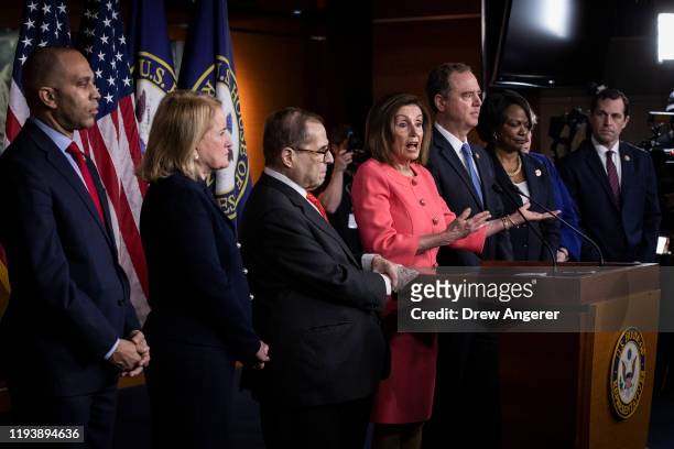 Surrounded by the seven impeachment managers, Speaker of the House Nancy Pelosi speaks during a press conference to announce the House impeachment...