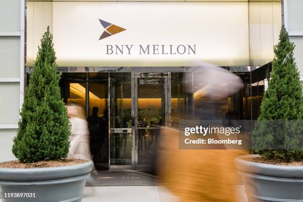 Pedestrians walk in front of a Bank of New York Mellon Corp. Office building in New York, U.S., on Monday, Jan. 13, 2020. BNY Mellon is scheduled to...