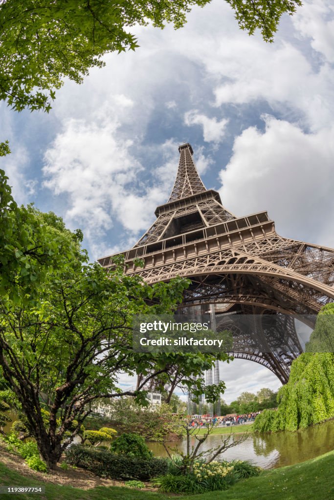 The iconic Parisian landmark Eiffel Tower and Champ de Mars on the Left Bank of Seine River in spring