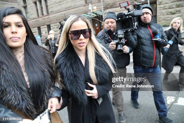 Chairgirl" Marcella Zoia leaves her postponed sentencing hearing at Old City Hall with a swarm of media.