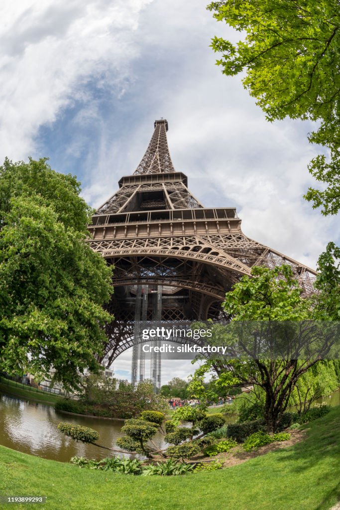 The iconic Parisian landmark Eiffel Tower and Champ de Mars on the Left Bank of Seine River in spring