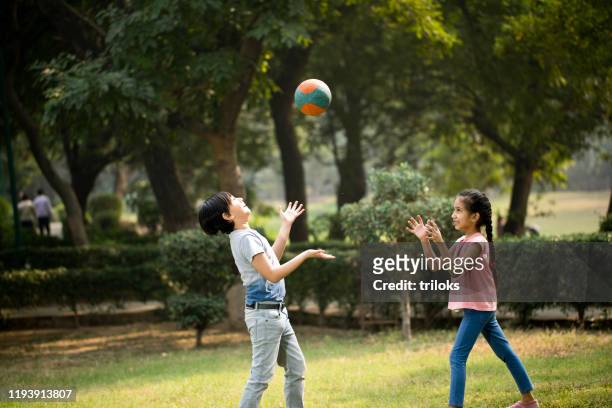 children playing with ball at park - kid throwing stock pictures, royalty-free photos & images