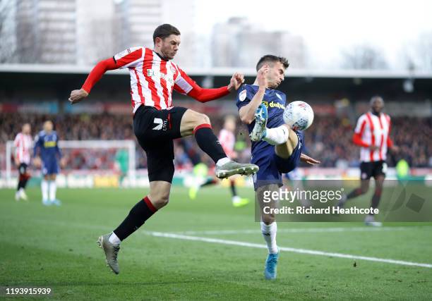 Henrik Dalsgaard of Brentford is tackled by Joe Bryan of Fulham during the Sky Bet Championship match between Brentford and Fulham at Griffin Park on...