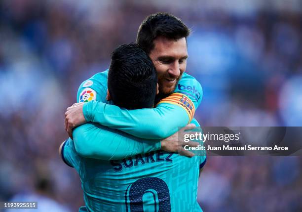 Luis Suarez of FC Barcelona celebrates with teammate Lionel Messi after scoring his team's second goal during the Liga match between Real Sociedad...