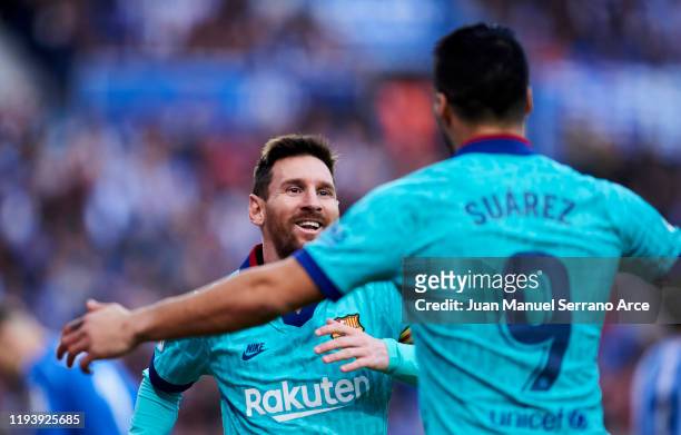Luis Suarez of FC Barcelona celebrates with teammate Lionel Messi after scoring his team's second goal during the Liga match between Real Sociedad...