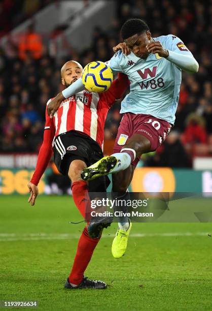 Kortney Hause of Aston Villa battles for possession with David McGoldrick of Sheffield United during the Premier League match between Sheffield...