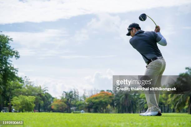 professional golf player is teeing off on green - tee off ストックフォトと画像